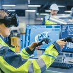 AVEVA Factory: Female Industrial Engineer Wearing Virtual Reality Headset and Holding Controllers, She Uses VR technology for Industrial Design, Development and Prototyping in CAD Software.